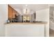 View from the kitchen, showing the breakfast bar, adjacent dining room, and the staircase at 5220 W Desert Ln, Laveen, AZ 85339