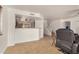 Open-concept view from a living room into the nearby kitchen and staircase to upper level at 5220 W Desert Ln, Laveen, AZ 85339