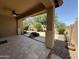 Covered backyard patio with tiled flooring, ceiling fan, and views of landscaped yard at 5420 S Mariposa Dr, Gilbert, AZ 85298