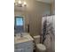Updated bathroom features a modern sink and a toilet with a decorative shower curtain at 5420 S Mariposa Dr, Gilbert, AZ 85298