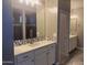 Modern bathroom with dual sinks, attractive lighting, mosaic tile, and a shower at 5420 S Mariposa Dr, Gilbert, AZ 85298