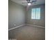 Bedroom with a ceiling fan, neutral gray walls, and carpet flooring at 5420 S Mariposa Dr, Gilbert, AZ 85298