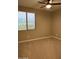 Neutral bedroom with a ceiling fan, window, and carpet flooring at 5420 S Mariposa Dr, Gilbert, AZ 85298