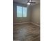 A spacious bedroom features a ceiling fan and neutral gray tile flooring at 5420 S Mariposa Dr, Gilbert, AZ 85298
