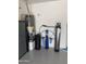 Garage featuring a water heater, water softener, utility sink, and overhead lighting at 5420 S Mariposa Dr, Gilbert, AZ 85298