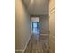 A neutral hallway with gray tile flooring leads to the open living area at 5420 S Mariposa Dr, Gilbert, AZ 85298