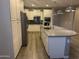 Bright kitchen featuring stainless steel appliances, white cabinets, a large island, and pendant lighting at 5420 S Mariposa Dr, Gilbert, AZ 85298