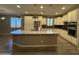 Contemporary kitchen featuring white cabinets, an island with a stone countertop, and stainless appliances at 5420 S Mariposa Dr, Gilbert, AZ 85298