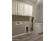 Laundry room with upper and lower cabinets, utility hookups, and tile floors at 5420 S Mariposa Dr, Gilbert, AZ 85298