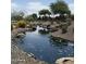 Scenic water feature with rocks and lush greenery enhances the community's natural beauty and tranquil atmosphere at 5420 S Mariposa Dr, Gilbert, AZ 85298