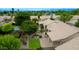 A serene aerial view of the home's backyard featuring a well-kept lawn, mature trees, and a private patio area at 5451 W Folley St, Chandler, AZ 85226