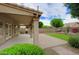 A charming back patio area complete with a covered space, lush greenery, and a brick-paved section for outdoor enjoyment at 5451 W Folley St, Chandler, AZ 85226