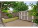 A backyard featuring a storage shed, a charming patio, and well-maintained landscaping for outdoor enjoyment at 5451 W Folley St, Chandler, AZ 85226
