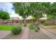A spacious backyard with lush landscaping, a well-manicured lawn, and a brick-paved pathway for outdoor enjoyment at 5451 W Folley St, Chandler, AZ 85226