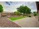 Spacious backyard featuring lush green grass, brick-lined flower beds, and a paved patio for outdoor enjoyment at 5451 W Folley St, Chandler, AZ 85226