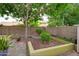 Private backyard oasis featuring manicured landscaping, mature trees, and brick-lined flower beds, creating a tranquil retreat at 5451 W Folley St, Chandler, AZ 85226