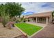 Expansive backyard featuring a well-manicured lawn, drought-tolerant landscaping, and a covered patio overlooking the yard at 5451 W Folley St, Chandler, AZ 85226