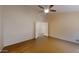 A good-sized bedroom with light colored walls and contrasting floor, ceiling fan, and double doors at 5451 W Folley St, Chandler, AZ 85226