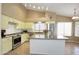 Bright kitchen with light-yellow cabinets, stainless steel appliances, and a functional center island, ideal for cooking at 5451 W Folley St, Chandler, AZ 85226