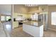 Well-lit kitchen with an island and stainless steel appliances flows into a comfortable living area, ideal for gatherings at 5451 W Folley St, Chandler, AZ 85226