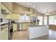 Vaulted kitchen features stainless appliances, tile floors, and breakfast bar at 5451 W Folley St, Chandler, AZ 85226
