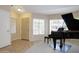 Living Room with ample windows, door, tile floors, and an elegant piano at 5451 W Folley St, Chandler, AZ 85226