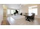 Spacious living room with a piano, dining area, and tile flooring, ideal for entertaining and comfortable living at 5451 W Folley St, Chandler, AZ 85226