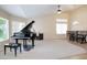 Open-concept living room featuring a grand piano, neutral carpet, and vaulted ceilings for an airy and elegant atmosphere at 5451 W Folley St, Chandler, AZ 85226