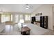 Bright living room with a comfortable white sofa, entertainment center, and access to the outdoors through French doors at 5451 W Folley St, Chandler, AZ 85226