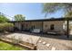 Inviting covered back patio with hanging porch swing, dining set, and string lights at 546 W Cambridge Ave, Phoenix, AZ 85003