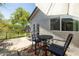 Charming back patio with outdoor dining set, a privacy fence, and lush greenery at 546 W Cambridge Ave, Phoenix, AZ 85003
