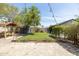 Lush backyard featuring a well-maintained lawn, string lights, and a brick-paved patio at 546 W Cambridge Ave, Phoenix, AZ 85003