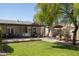 Spacious backyard with patio, porch swing, garden area, mature trees, and privacy fence at 546 W Cambridge Ave, Phoenix, AZ 85003