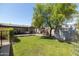 Large backyard offering a grass lawn, covered patio, garden area, and storage shed at 546 W Cambridge Ave, Phoenix, AZ 85003