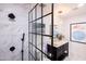 Updated bathroom with a glass shower enclosure, modern vanity, and stylish lighting fixtures at 546 W Cambridge Ave, Phoenix, AZ 85003