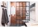 Modern bathroom with glass enclosed shower with brick accents, contemporary fixtures, and marble tiling at 546 W Cambridge Ave, Phoenix, AZ 85003