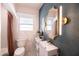 Stylish bathroom with blue geometric tiled wall, modern vanity and decorative mirror at 546 W Cambridge Ave, Phoenix, AZ 85003