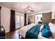 Bright bedroom featuring French doors, hardwood floors, and a stylish barn door to the bathroom at 546 W Cambridge Ave, Phoenix, AZ 85003