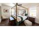 Comfortable bedroom with a four-poster bed, dark hardwood floors and two windows at 546 W Cambridge Ave, Phoenix, AZ 85003