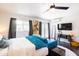 Bright bedroom with a comfortable turquoise sofa, en-suite, and a view to the outside at 546 W Cambridge Ave, Phoenix, AZ 85003