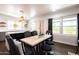 Dining area with stylish seating, a modern table, and a view into the contemporary kitchen at 546 W Cambridge Ave, Phoenix, AZ 85003