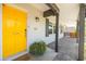 Charming front porch featuring a bright yellow door and a welcoming entrance at 546 W Cambridge Ave, Phoenix, AZ 85003