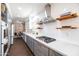A modern kitchen with stainless steel appliances, gray cabinets and white countertops at 546 W Cambridge Ave, Phoenix, AZ 85003