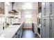 Bright modern kitchen with stainless appliances, gray cabinets and stunning hardwood floors at 546 W Cambridge Ave, Phoenix, AZ 85003