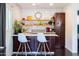 Charming butler's pantry with white subway tile, open shelving and dark cabinets at 546 W Cambridge Ave, Phoenix, AZ 85003