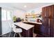 Charming butler's pantry with white subway tile, open shelving and dark cabinets at 546 W Cambridge Ave, Phoenix, AZ 85003
