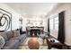 Bright living room featuring contemporary decor, a gray sofa, and an open floor plan connecting to the dining area at 546 W Cambridge Ave, Phoenix, AZ 85003
