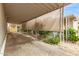 Long carport offers covered parking and protection from the elements with mature landscaping nearby at 5601 W Missouri Ave # 254, Glendale, AZ 85301