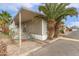 Charming single-story home with covered porch, palm trees, and desert landscaping at 5601 W Missouri Ave # 254, Glendale, AZ 85301
