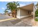 Street view of single-story home with mature palm trees and covered parking at 5601 W Missouri Ave # 254, Glendale, AZ 85301